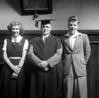 Inverness Royal Academy Dux 1948-1949. Rector MacDonald with James Mackenzie and Aileen Barr. The document hanging on the wall is a framed copy of an extract from Capt. William Mackintosh's will, which provided funding for children of the name of Mackintosh to receive free education, mainly at the Academy. 