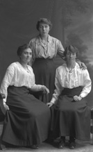Three women, possibly sisters, posing in studio. Original plate broken on corner.#