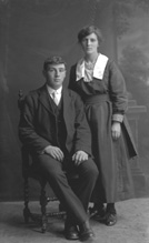 Young couple, man seated.# 
