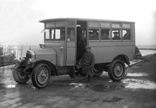 The Ferry Omnibus. Owned by Mr W. Greig, the 1921 Vulcan (ST1410) was the first bus in Inverness with pneumatic tyres. A note on the side panel indicates its speed was 12 mph. The standing conductor is M. Greig. * 