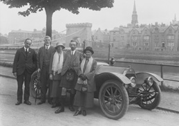 Scottish Home Rule Group outside the Palace Hotel, standing beside vintage car with Ness Bridge and the old Caledonian Hotel (demolished 1960s) in the background. Badge on front of the vehicle, RMC, possibly stands for Renault Motor Company. (Scot Auto Ass. Glasgow written on envelope?)*