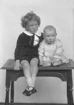 Grant, young boy and baby on table.