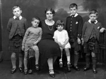 Jessie Macleod (nee Macrae) with Colin, Lorne, Duncan, Dodo and Ishbel. Jessie was a stage actress (see 26822b - the 1927 production of 'The Geisha'). Her husband was Colin Macleod. This family portrait was taken c1925. The boy Colin Macleod served during WWII in the Royal Navy. After being de-mobbed in 1946, he joined the merchant navy, where he rose to the rank of captain. During the early 1960s, he left the service and became Harbour Master at Inverness. He held this position for several years before re-joining the merchant navy. Lorne Macleod became a dentist and had his own practice in Huntly Street until he emigrated to Australia in 1967. Duncan Macleod also became a dentist with a practice in Boness and later Edinburgh. Donald 'Dodo' Macleod remained in Inverness and played football in his younger days for Inverness Thistle Football Club. Information kindly provided by Jessie's grandson Duncan Phillips.
