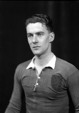 Portrait. The badge on the sports shirt shows a cat and a stag's head. #