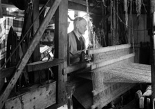 Weaver with loom.*