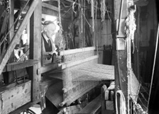 Weaver with loom.*