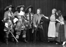 Theatrical actors dressed in costume. #