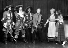 Theatrical actors dressed in costume. #