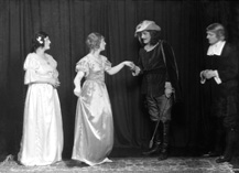 Theatrical actors dressed in costume. #