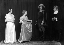 Theatrical actors dressed in costume. #