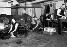Messrs Alexander MacDonald & Co, Wine Merchants, 49-53 Church Street, Inverness (established 1837). Cellar workers bottling.*  