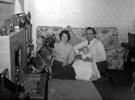 Family and dog in sitting room, taken for a Christmas card. Name on envelope is Helen Marie. #