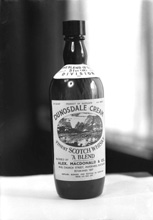 Messrs Alexander MacDonald & Co, Wine Merchants, 49-53 Church Street, Inverness (established 1837). A  bottle of their Dunosdale Cream blended whisky, 'The Blend of the 51st (H) Division.'* 