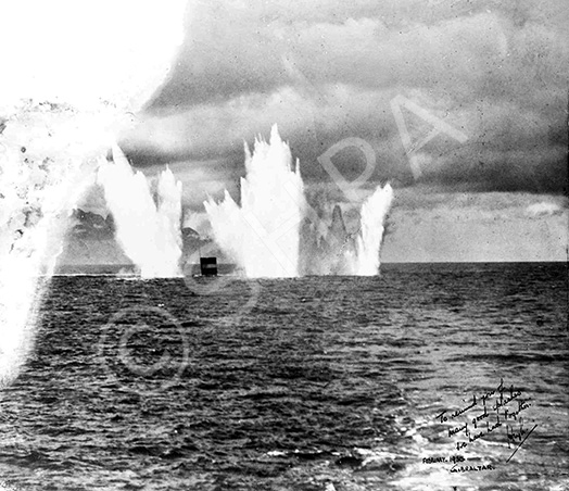 Shells landing on target fired from HMS Barham at 10 mile range. Copy made in February 1952. Inscription reads: To remind you of many good splashes we have had together. Hugh. February 1930, Gibraltar.