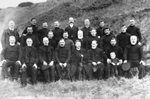 Copy of Ardersier fishermen and a minister c1900 for Mr Johnstone, Australia. Seated left to right: 'Pettachan' Johnstone, Alexander 'Sandy' Cameron, John Johnstone ('Jocky Petty'), Davy Johnstone, Reverend Paton or D. McLeod (?), 'Paddy', Sonny (or Sammy) Davidson and son 'Bumber', and Donald 'Dole' Johnstone. Middle row left to right: Dave Cameron, William Bow (?), Alex 'Moses' Johnstone, Donald Cameron, Aly MacDonald, Dunk Johnstone, Nicky Davidson, and Jim Johnstone. Back row left to right: Alex 'Oak' Davidson, John Cameron, James Main, 'Secky' (?) Campbell, James Forsythe ('Jimmak the Mason'), Jamie Paddy, and Davie 'Honeyman' Main.