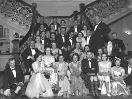 Group of people at a function, seated on the staircase in the Station Hotel, Inverness (now the Royal Highland Hotel). It is believed the stairs were used as the model for the Grand Staircase on the Titanic. # 