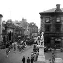 March past Station Square, Academy Street, Inverness. Possibly the Pipes and Drums of the Depot Seaforth, Fort George, leading a draft of soldiers to Inverness Station. *
