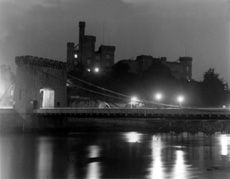 Inverness Castle from the river, featuring the old bridge at night. Spans of the 'temporary bridge' can be seen upriver beneath the old bridge. Courtesy John and Aithne Barron. *