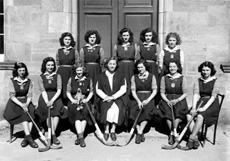 Hockey 1st XI 1947-1948. Team members were: Aileen Barr (C), Sheila S. Cameron (VC), Belle Munro (Sec), Peggy MacLeod, Margaret MacLennan, Margaret Corbett, Maisie Forsyth, Adele Mitchell, Isobyl Bauchop, Erica B. Donald and another. At centre is Miss Maude Yule. (Courtesy Inverness Royal Academy Archive IRAA_018).