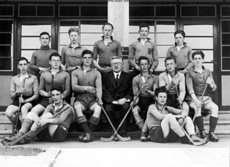 Shinty 1944-1945. Rear: T. Forrester, A. Cook,       A. MacDougall, S. Mackenzie, J. MacDougall. Middle: A. Wilson, R. MacKenzie, A. MacLeod,          Mr Graham, D. Campbell, B. Heatley, A. McDonald. Front: I. Mitchell, J. MacCartney. (Courtesy Inverness Royal Academy Archive IRAA_027).