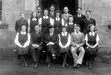 The first Prefects at the Inverness Royal Academy, appointed in May 1944 by the then new Rector D.J MacDonald. Rear: Andrew MacLaren, John Hill, Deverell Neill, James McPhee. Middle: Allan Cook, Evelyn Cameron, Eiona Moir, Irene Stewart, Marjory MacVinish, Simon MacMillan. Front: Mary Wylie, Callum MacAulay (C), Rector D.J MacDonald, Margaret Stewart (VC), James Cattell (VC), Isobel Mackay. (Prefect Jas Jackson left half-way through the term, replaced by Andrew MacLaren.) (Courtesy Inverness Royal Academy Archive IRAA_043).