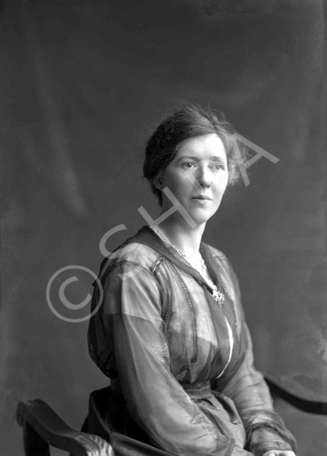 Woman portrait. She is wearing a nurse uniform in image 21705a.#