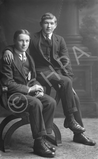 Two young men, both seated, possibly brothers.#    