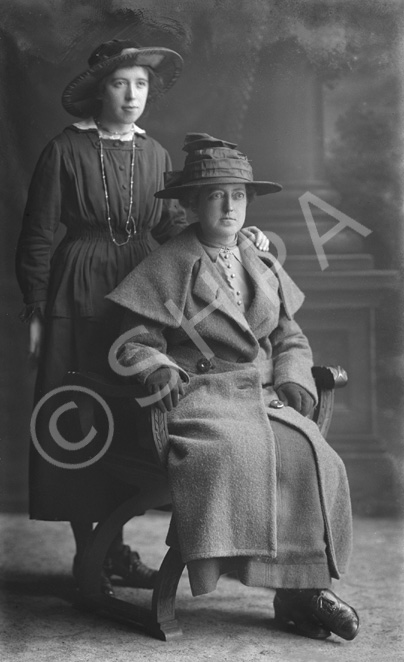 Mother and daughter, mother seated.#   