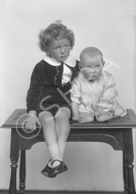 Grant, young boy and baby on table.