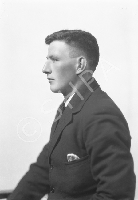 Man wearing suit in profile.#