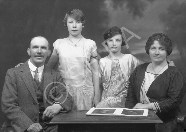 Family portrait around table.#