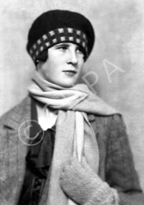 Woman with scarf and tartan bonnet.#