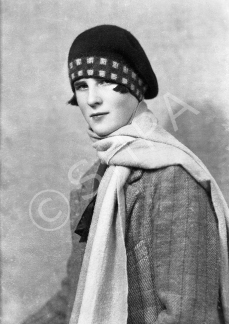 Woman with scarf and tartan bonnet.#