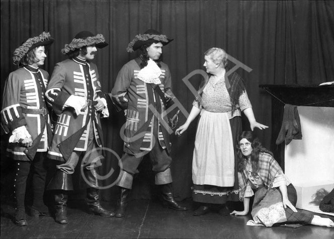 Theatrical actors dressed in costume. #