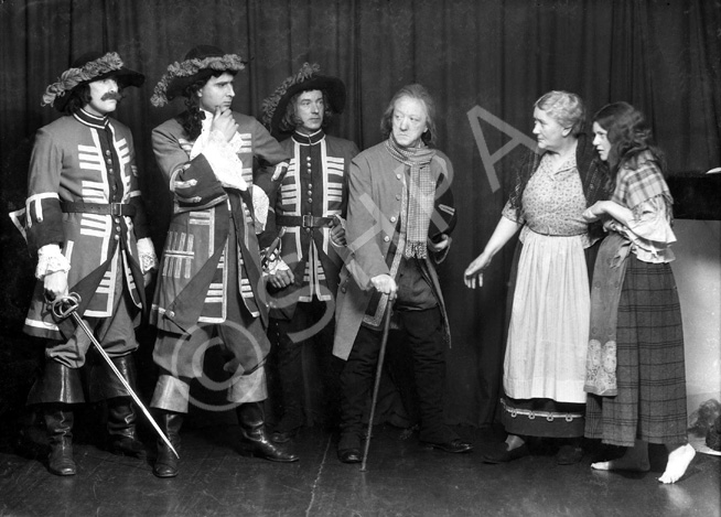 Theatrical actors dressed in costume. #