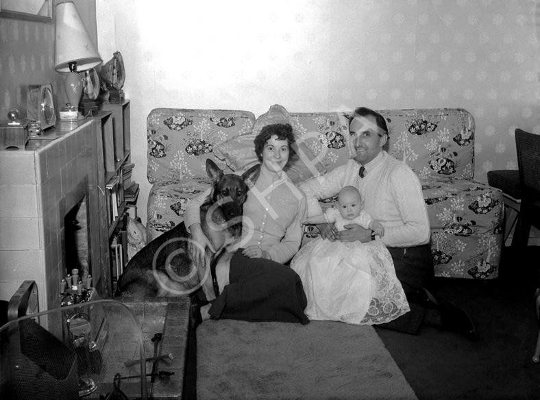 Family and dog in sitting room, taken for a Christmas card. Name on envelope is Helen Marie. #