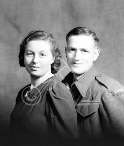 Mrs Weir, Nairn. He wears a 'Canada' arm patch on left sleeve.