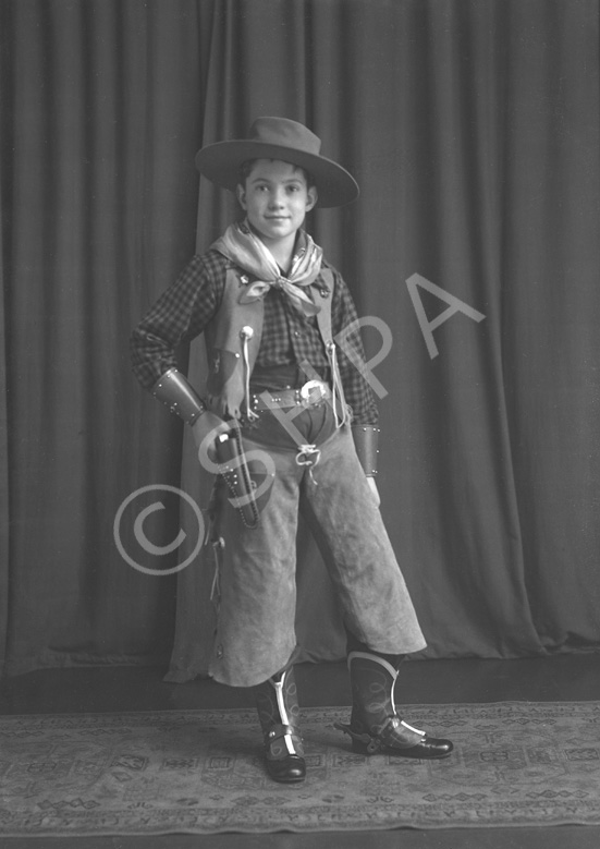 Andrew Chalmers dressed in a cowboy costume for a fancy dress party c1947. (see also refs: 33898, 39550 and 45474). He was a grandson of the famous photographer Andrew Paterson (1877-1948).
