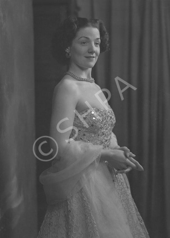 Miss Cairns, Station Hotel, Inverness, in ball gown, standing. Other images also under code 42904.