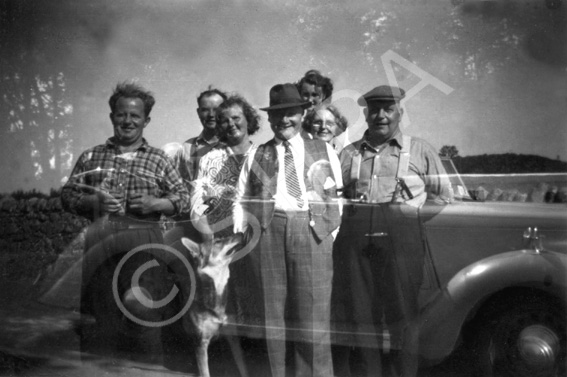 Double exposure of group of people standing and people sitting in a car. #