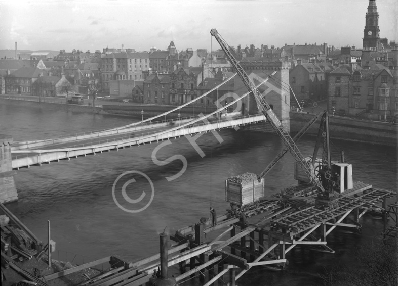 Building temporary bridge over the River Ness in 1939.*