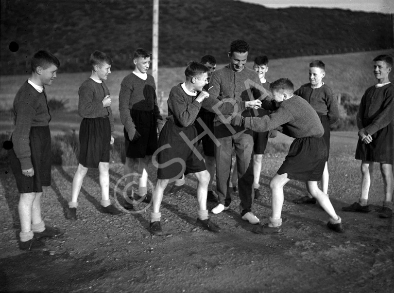 Youths sparring in boxing match. #