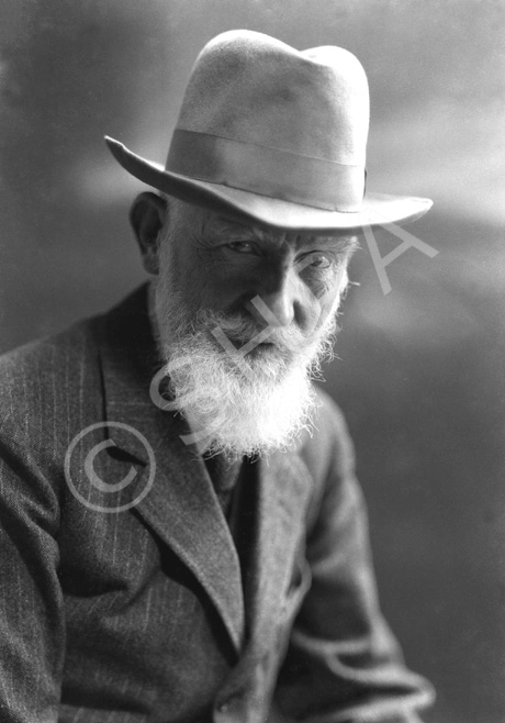 George Bernard Shaw (1856-1950) was an Irish playwright and a co-founder of the London School of Economics. He wrote more than 60 plays and is the only person to have been awarded both a Nobel Prize in Literature (1925) and an Oscar (1938), for his contributions to literature and for his work on the film 'Pygmalion' (adaptation of his play of the same name). In 1898, Shaw married Charlotte Payne-Townshend whom he survived. They settled in Ayot St Lawrence in a house now called Shaw's Corner. In 1925 he was staying in Thurso; having been ill his wife had taken him to Caithness and then to Orkney for his convalescence, and it is probable this image dates from that time. Shaw died in Ayot St Lawrence, aged 94, from chronic problems exacerbated by injuries he incurred by falling from a ladder.