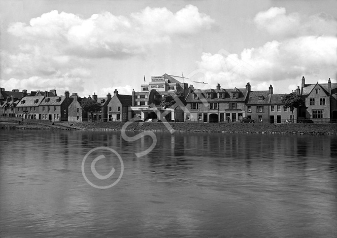 The River Ness and the Palace Cinema. The banner is promoting the movie 'Flight From Justice,' an American romantic drama released in 1938, directed by Nick Grinde. The film stars Robert Livingston, June Travis, John Gallaudet, Charles Halton and Ben Welden. For other images of the River Ness see H-0006, H-0009, H-0194, H-0195 and H-0196. For Palace Cinema interiors see 32034a/e. *