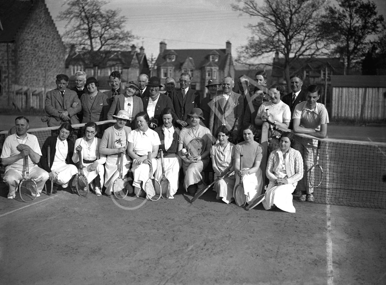 Mixed group on tennis court. #